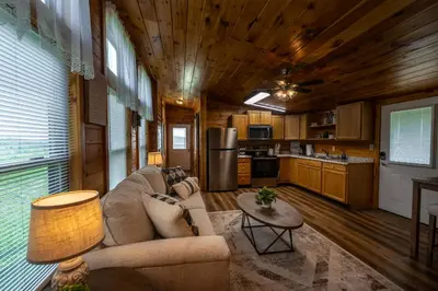 a living room with a couch and a table at Rustic Mt Sterling Cabin2 Near Downtown Pets OK in Mount Sterling