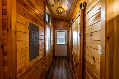 a hallway in a wooden cabin with a door at Rustic Mt Sterling Cabin2 Near Downtown Pets OK in Mount Sterling