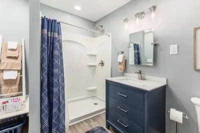 a bathroom with a sink and a shower at The Mad Cat Inn in Lewis Center