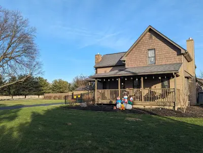 a house with a porch with balloons on it at The Lazy Cat Lodge in Lewis Center