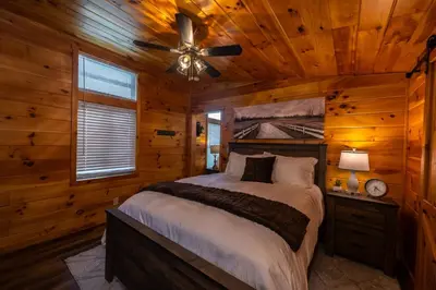 a bedroom with a bed and a ceiling fan at Rustic Mt Sterling Cabin1 Near Downtown Pets OK in Mount Sterling
