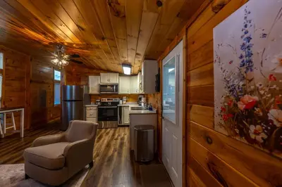 a kitchen with a couch and a chair in a room at Rustic Mt Sterling Cabin1 Near Downtown Pets OK in Mount Sterling