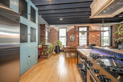 a kitchen with a stove and a table in it at The Brick Dachshund - Chic for 9