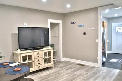 a living room with a flat screen tv on a stand at Updated Lakewood Retreat! in Lakewood