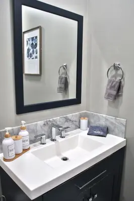 a bathroom with a white sink and a mirror at Updated Lakewood Retreat! in Lakewood