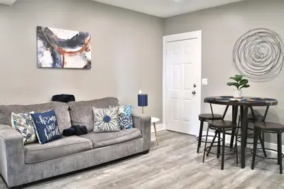 a living room with a couch and a table at Updated Lakewood Retreat! in Lakewood