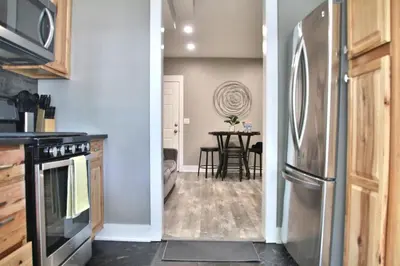 a kitchen and dining room with a stainless steel refrigerator at Updated Lakewood Retreat! in Lakewood
