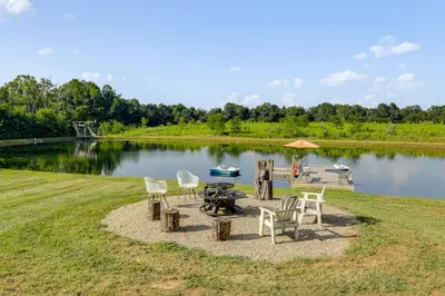 a group of chairs and a table next to a lake at Private Ponds and Trails Hillsboro Nature Retreat! in Hillsboro