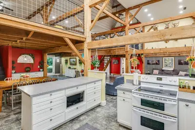 a large kitchen with white appliances and a dining room at Private Ponds and Trails Hillsboro Nature Retreat! in Hillsboro