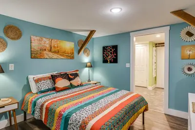 a bedroom with a bed with blue walls at Private Ponds and Trails Hillsboro Nature Retreat! in Hillsboro
