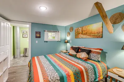 a bedroom with a bed and blue walls at Private Ponds and Trails Hillsboro Nature Retreat! in Hillsboro