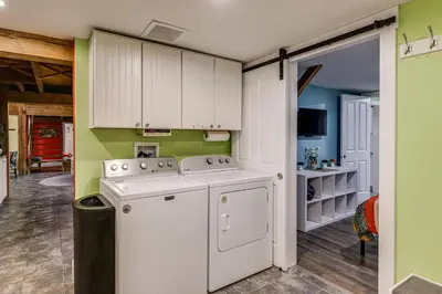 a kitchen with a stove and a washer and dryer at Private Ponds and Trails Hillsboro Nature Retreat! in Hillsboro