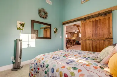 a bedroom with a bed and a sliding door at Private Ponds and Trails Hillsboro Nature Retreat! in Hillsboro
