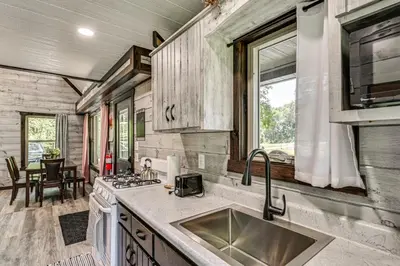 a kitchen with a sink and a stove at Ohio Amish Country Getaway Fish, Hike, Boat! in Sugarcreek