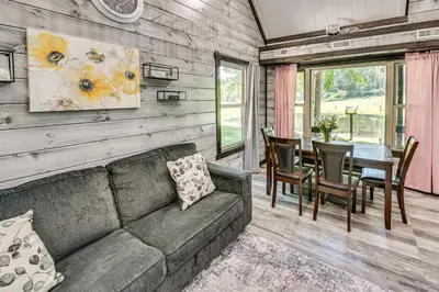 a living room with a couch and a table at Ohio Amish Country Getaway Fish, Hike, Boat! in Sugarcreek