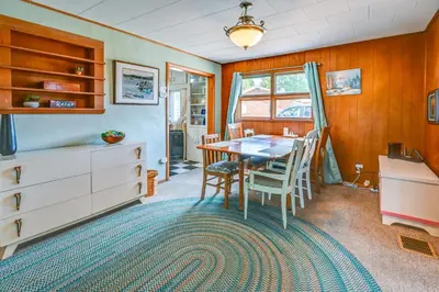 a dining room with a table and chairs at Boat and Unwind! Charming Atwood Lake Farmhouse in Dellroy