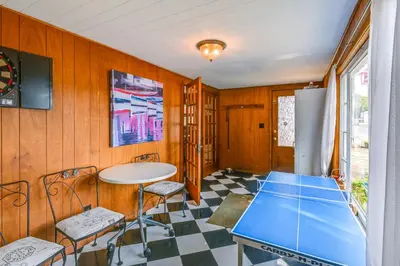a kitchen with a table and chairs in a room at Boat and Unwind! Charming Atwood Lake Farmhouse in Dellroy