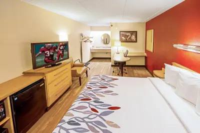 a hotel room with a bed and a flat screen tv at Red Roof Inn St Clairsville - Wheeling West in Saint Clairsville