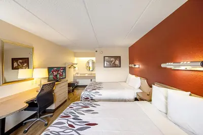 a hotel room with two beds and a desk at Red Roof Inn St Clairsville - Wheeling West in Saint Clairsville