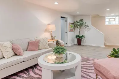 a living room with a couch and a table at Stylish 3BR w Sunroom & Deck in Cleveland