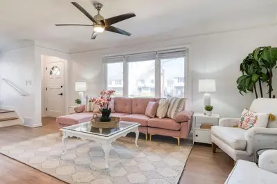 a living room with a couch and a table at Stylish 3BR w Sunroom & Deck in Cleveland