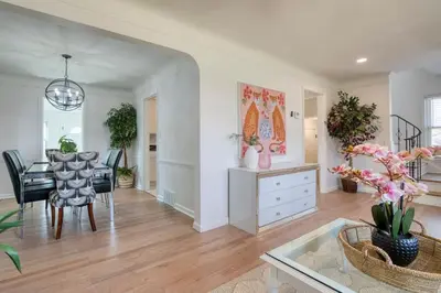 a living room with a table and a dining room at Stylish 3BR w Sunroom & Deck in Cleveland