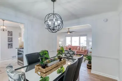 a dining room and living room with a table and chairs at Stylish 3BR w Sunroom & Deck in Cleveland