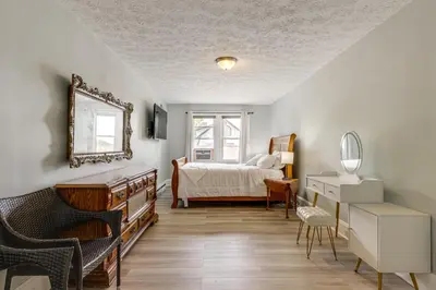 a bedroom with a bed and a mirror and a dresser at Modern Group Getaway with Private Yard in Cincinnati in Cincinnati