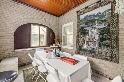 a dining room with a table and a painting on the wall at Modern Group Getaway with Private Yard in Cincinnati in Cincinnati