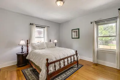 a bedroom with a bed and two windows at Modern Group Getaway with Private Yard in Cincinnati in Cincinnati
