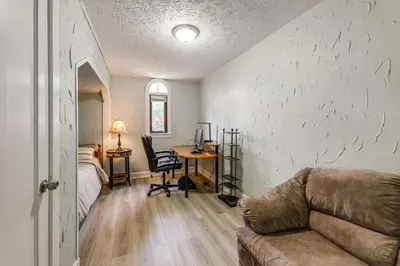 a living room with a couch and a desk at Modern Group Getaway with Private Yard in Cincinnati in Cincinnati