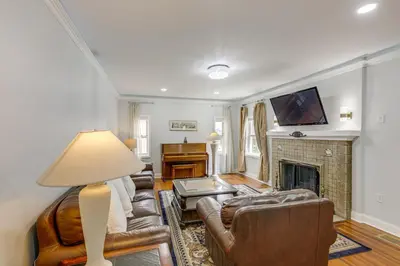 a living room with a couch and a fireplace at Modern Group Getaway with Private Yard in Cincinnati in Cincinnati