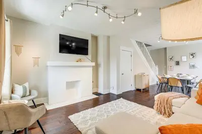 a living room with a couch and a fireplace at 6 Mi to Ohio State Walkable Home in S Columbus! in Columbus