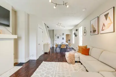 a living room with a couch and a table at 6 Mi to Ohio State Walkable Home in S Columbus! in Columbus