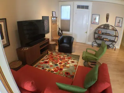 a living room with a red couch and a television at Center of Action PARK ONSITE Gated on 2nd Fl in Cincinnati