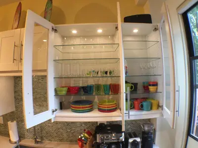 a kitchen cabinet with plates and cups in it at Center of Action PARK ONSITE Gated on 2nd Fl in Cincinnati