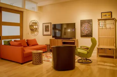 a living room with a couch and a television at Center of Action PARK ONSITE Gated on 2nd Fl in Cincinnati