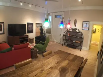 a living room with a table and chairs and a tv at Center of Action PARK ONSITE Gated on 2nd Fl in Cincinnati