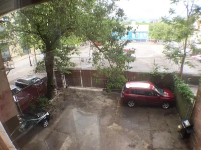 a red car parked in a parking lot at Center of Action PARK ONSITE Gated on 2nd Fl in Cincinnati