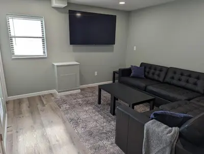 a living room with a couch and a tv at The Calico Cottage in Lewis Center