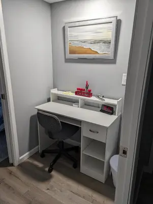 a white desk with a chair in a room at The Calico Cottage in Lewis Center