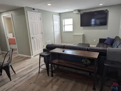 a living room with a couch and a table at The Calico Cottage in Lewis Center