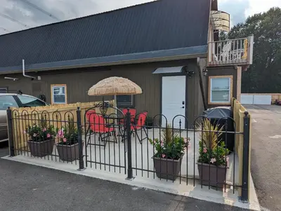 a fence with potted plants in front of a building at The Calico Cottage in Lewis Center