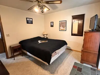 a bedroom with a bed and a ceiling fan at Whispering Pines Auburn in Auburn