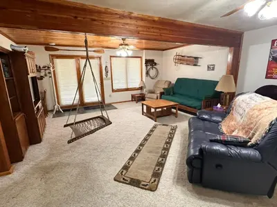 a living room with a couch and a swing at Whispering Pines Auburn in Auburn