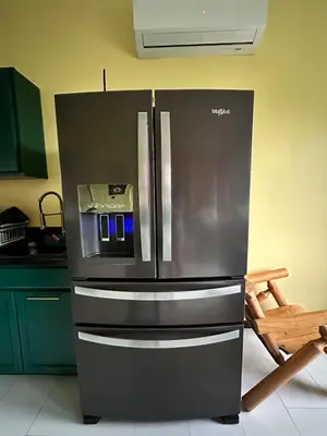 a kitchen with a stainless steel refrigerator with a microwave at Buddhas Little Cabin! 1 min from Palace of Gold in Moundsville