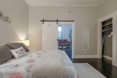 a bedroom with a bed and a living room at Riverside Hideaway just outside of downtown Cincy in Cincinnati