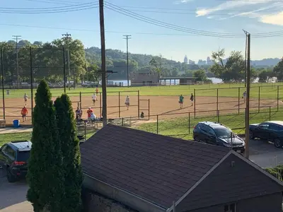 a baseball game in a field with people playing at Riverside Hideaway just outside of downtown Cincy in Cincinnati