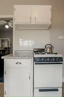 a kitchen with a stove with a tea pot on it at Riverside Hideaway just outside of downtown Cincy in Cincinnati