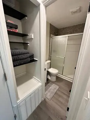 a small bathroom with a toilet and a shower at KING bed, Pet Friendly, Modern Retreat in CLE-BW in Berea